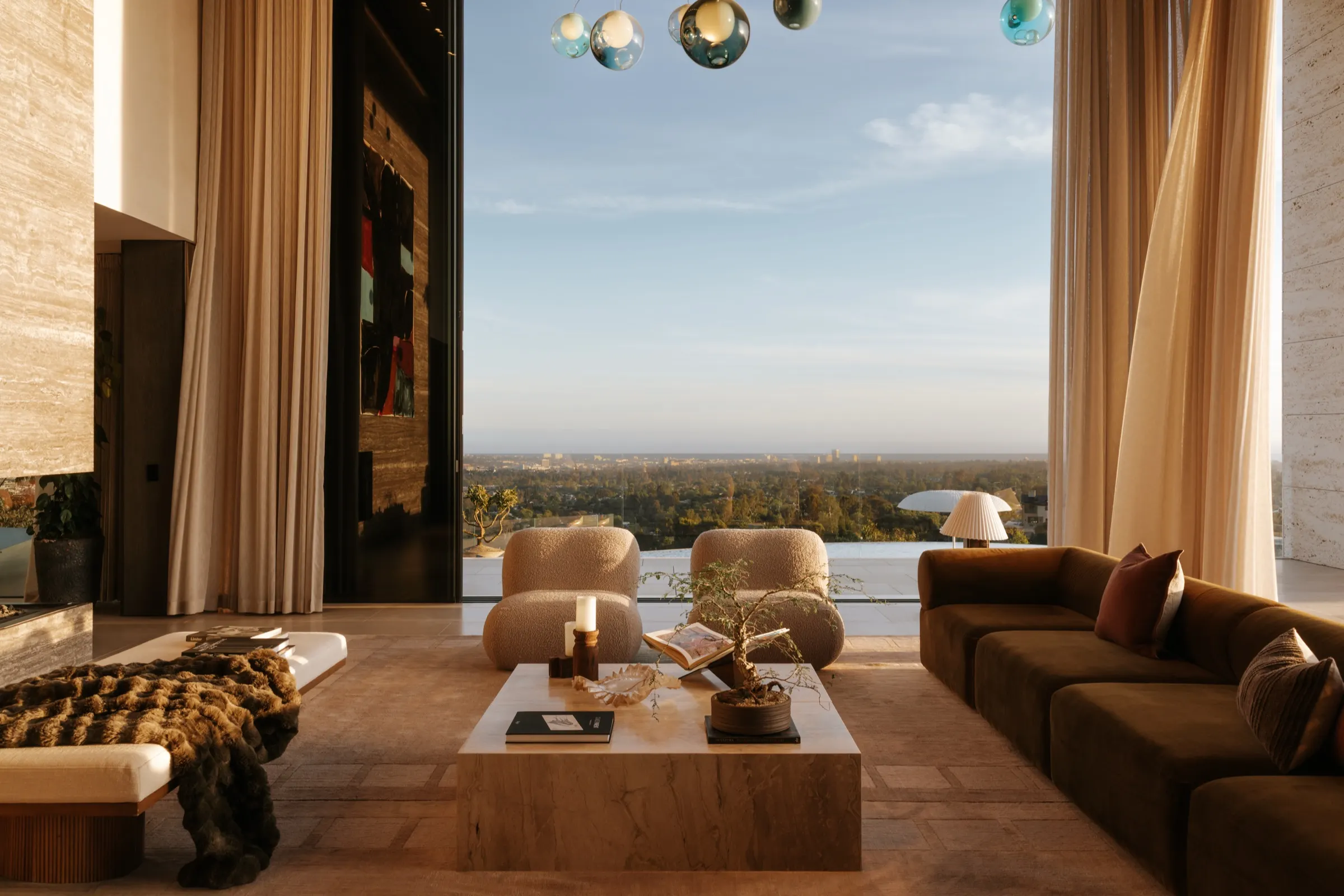 The Getty House, Brentwood — great room with two-story glass and linen drapes over the city