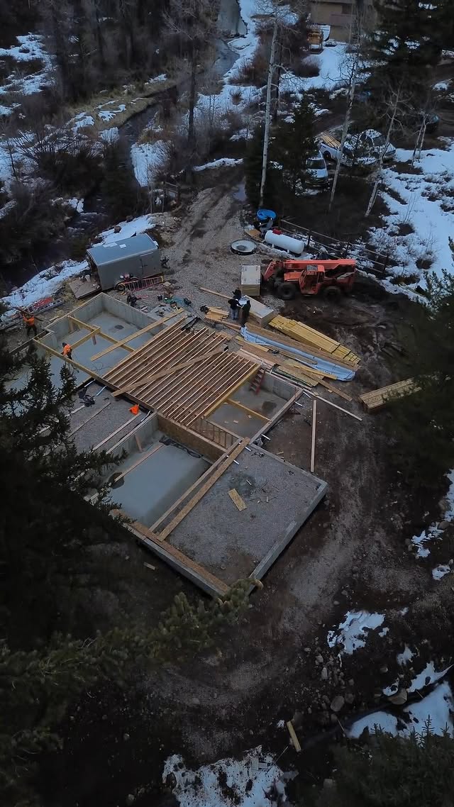 Groundbreaking — new build surrounded by evergreens