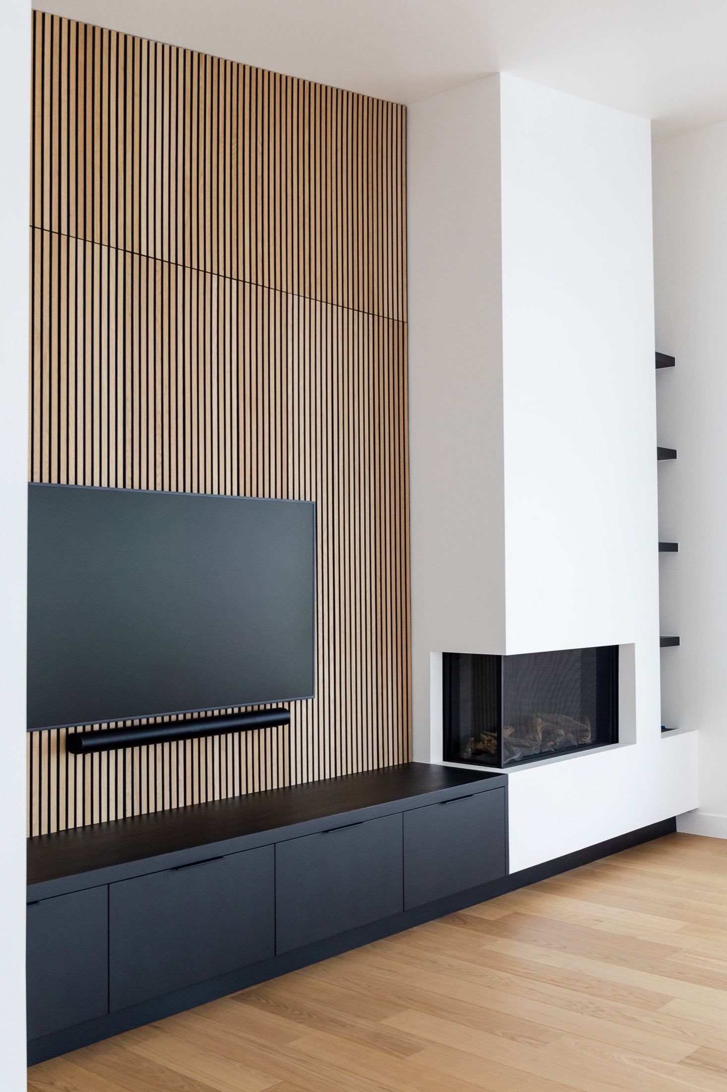 Benloch Ranch Lot 66 — living room, wood-slat accent wall, linear fireplace, built-in cabinetry