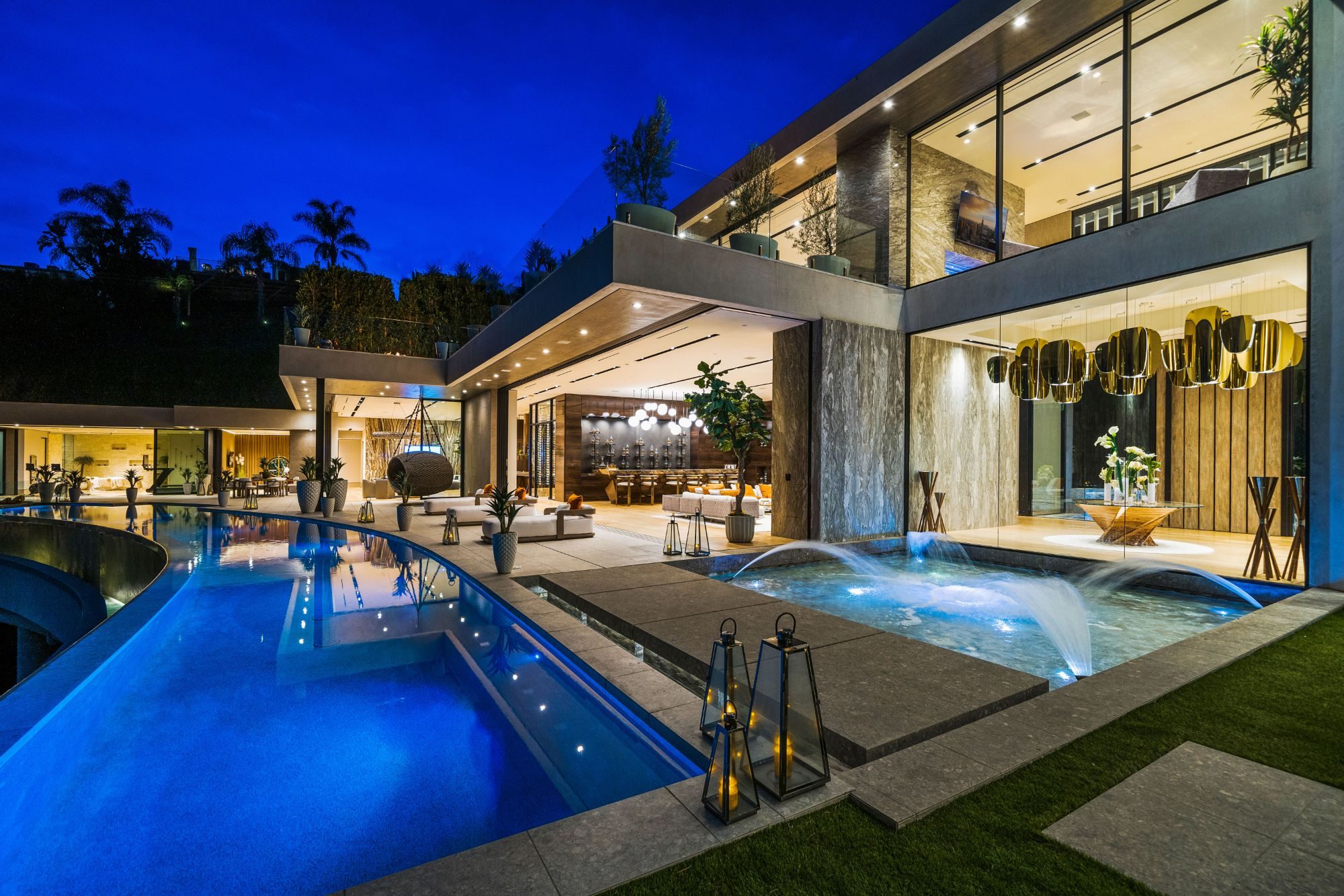 The Flicker Estate curved pool and fountains at dusk