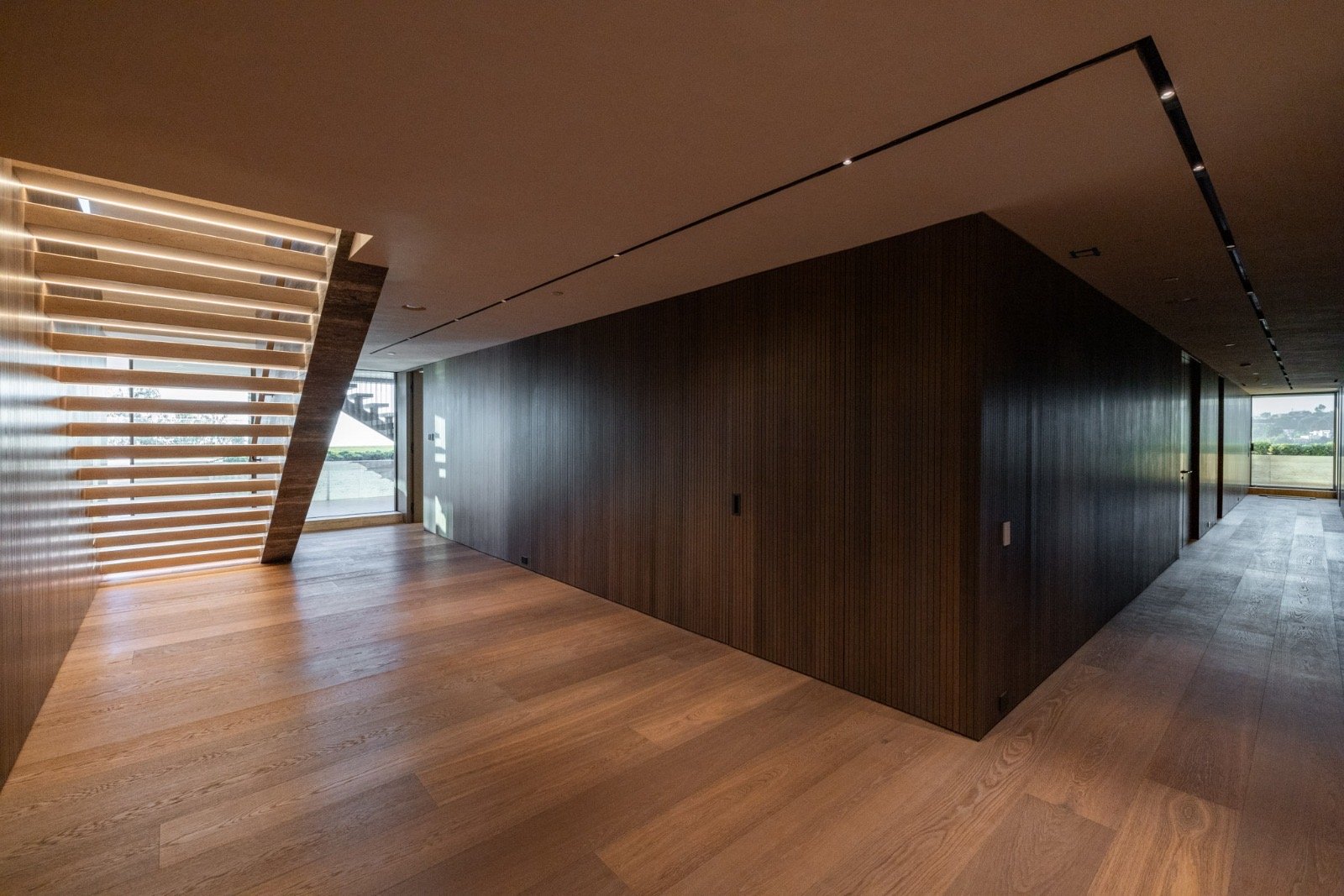 The Getty House — 684Firth Brentwood CA LA Upper Hallway Wood Panels Hardwood Floor Linear Lighting Slatted Window  Modern Home