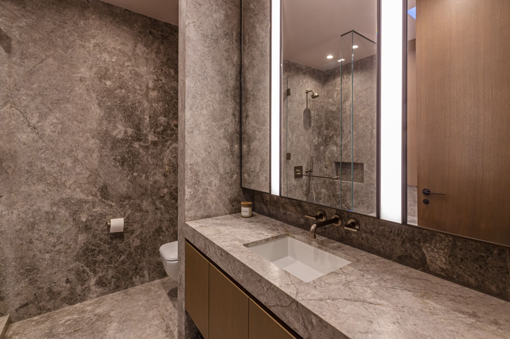 Getty House — powder room in full-height marble