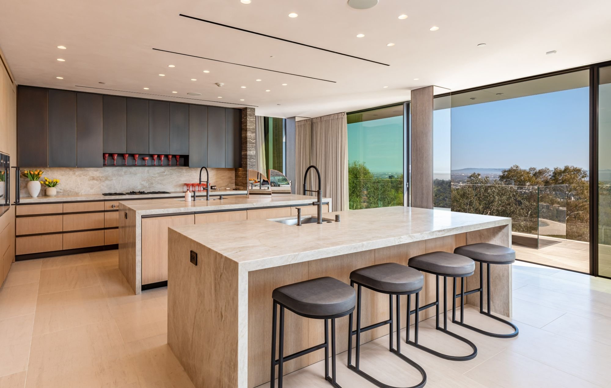 Getty House — kitchen with wood cabinetry and stone waterfall counters
