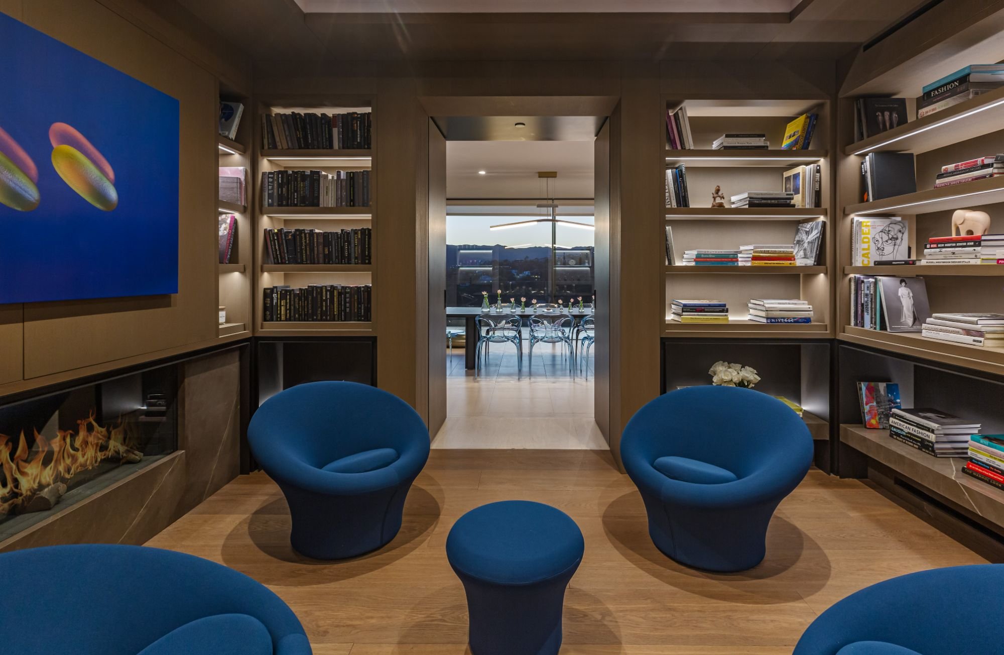 Getty House — library reading nook with built-in shelving and modern fireplace