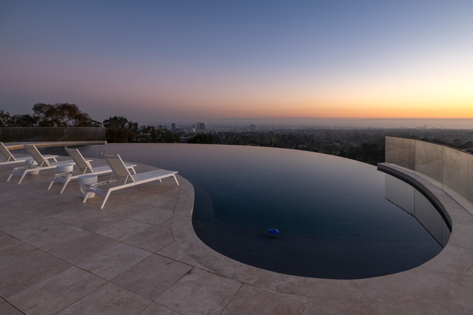 Getty House — infinity-edge pool at sunset with city views