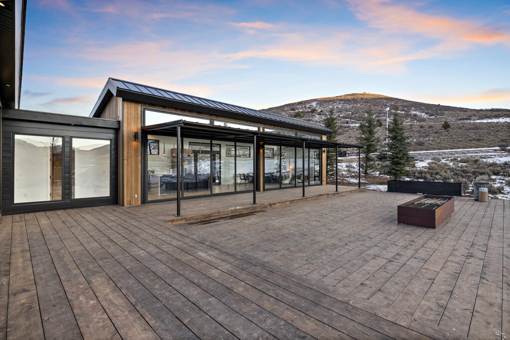 Icon Haus — covered wood deck with fire pit and mountain view