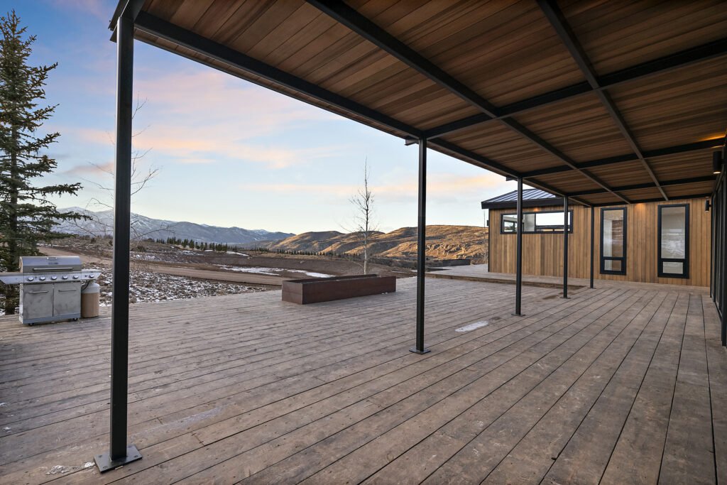 Icon Haus — covered outdoor kitchen and deck framing the mountains