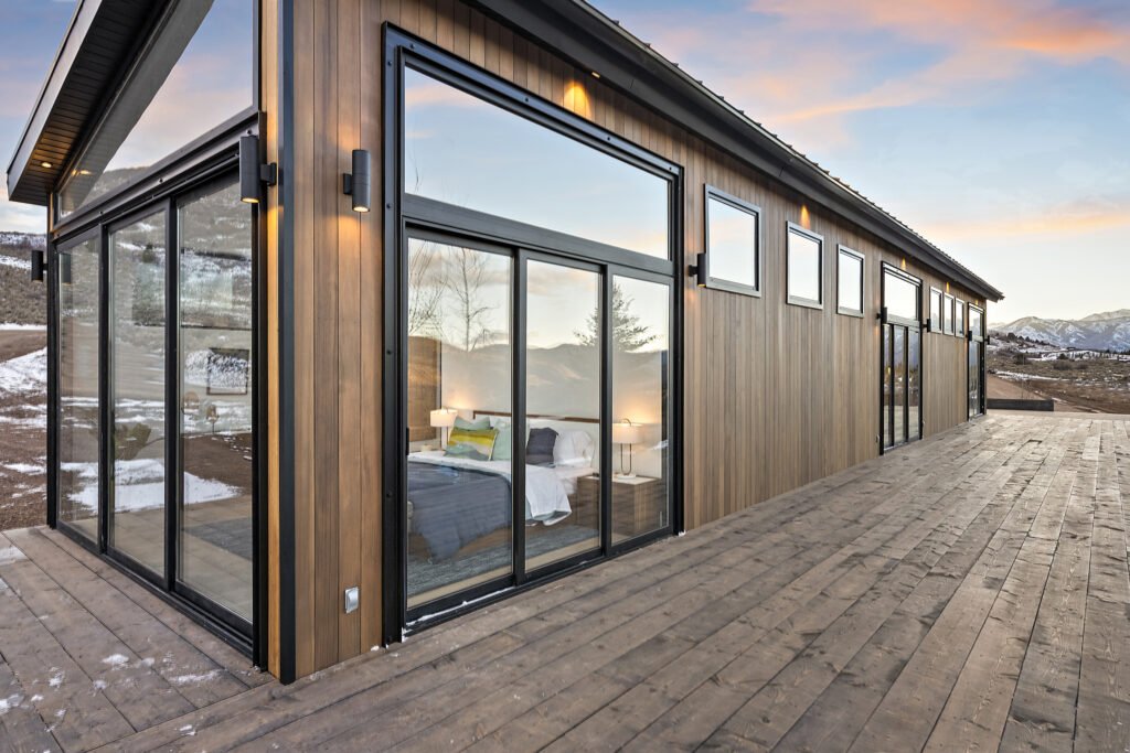Icon Haus — wood deck with horizontal windows and sliding glass door