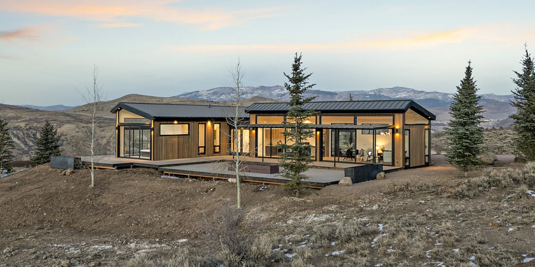 Icon Haus — hillside view of the wood-and-glass façade above Benloch Ranch