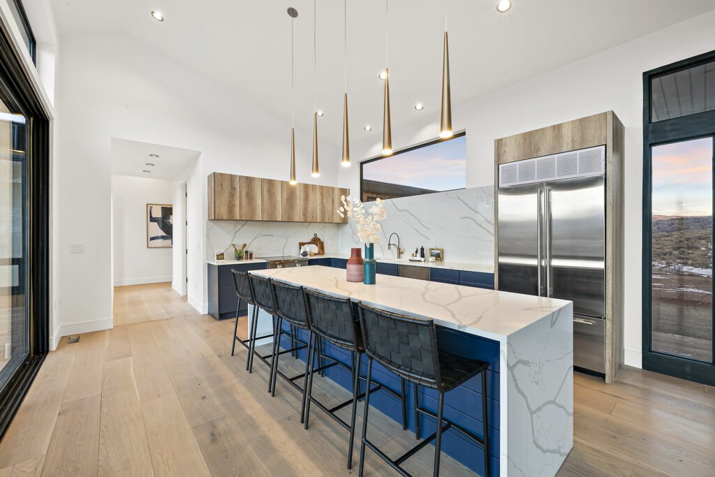 Icon Haus — Icon House Benloch Heber City Kitchen Blue Island Quartz Countertop Brass Pendants Hallway View  Modern Custom