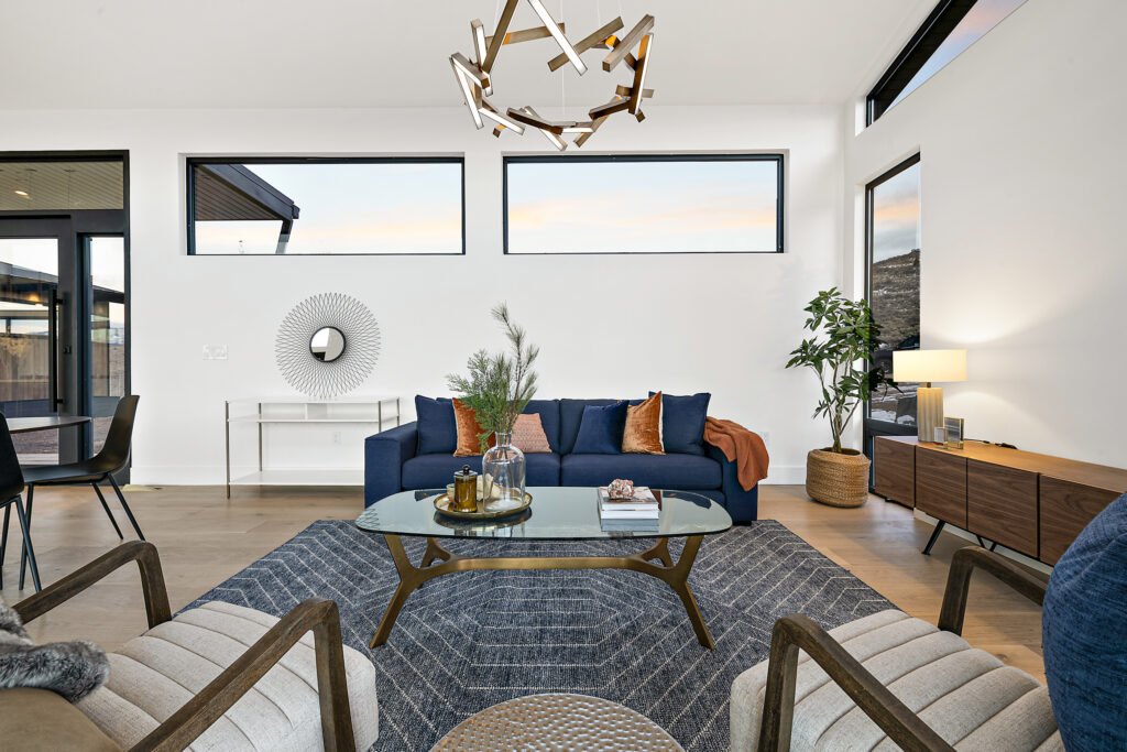 Icon Haus — living room with navy sofa, sculptural chandelier and mid-century credenza