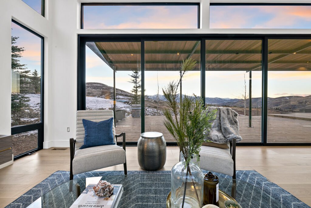 Icon Haus — living room sliding glass doors opening to the covered deck