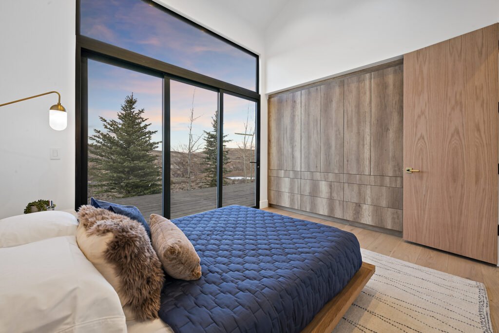 Icon Haus — master bedroom with sliding door to the mountain view