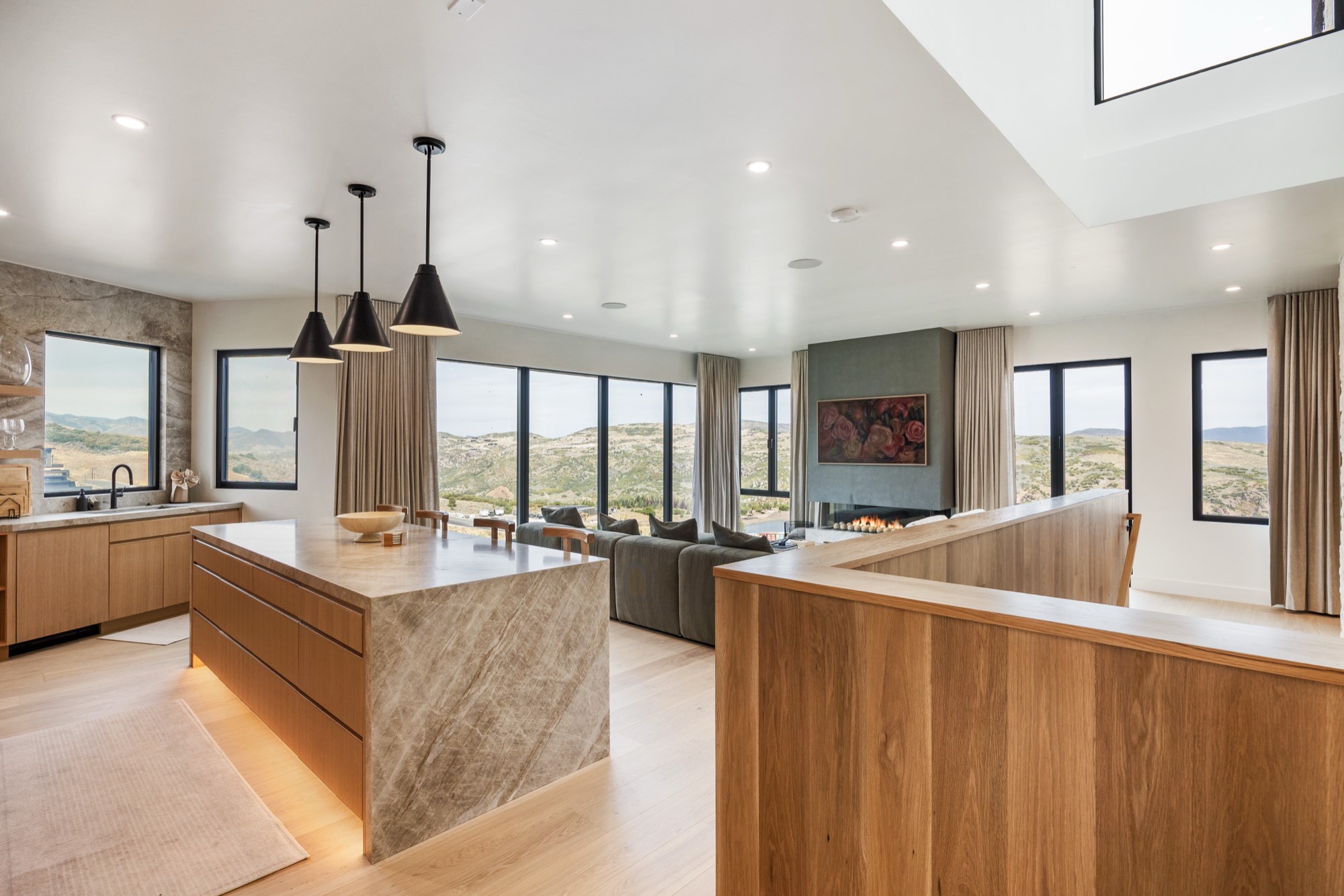 Islay Way — open great room with quartzite island and valley view wall