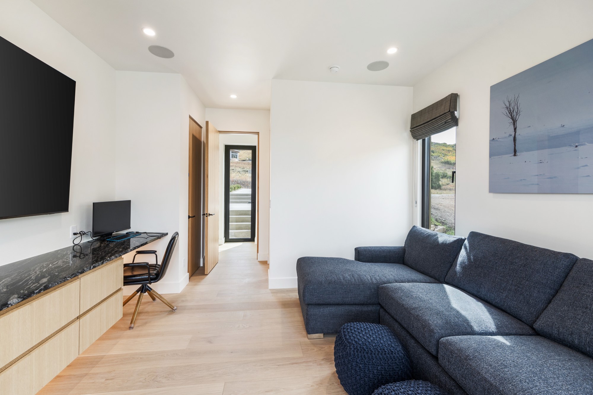 Islay Way — rear patio and fire pit against the fall hillside