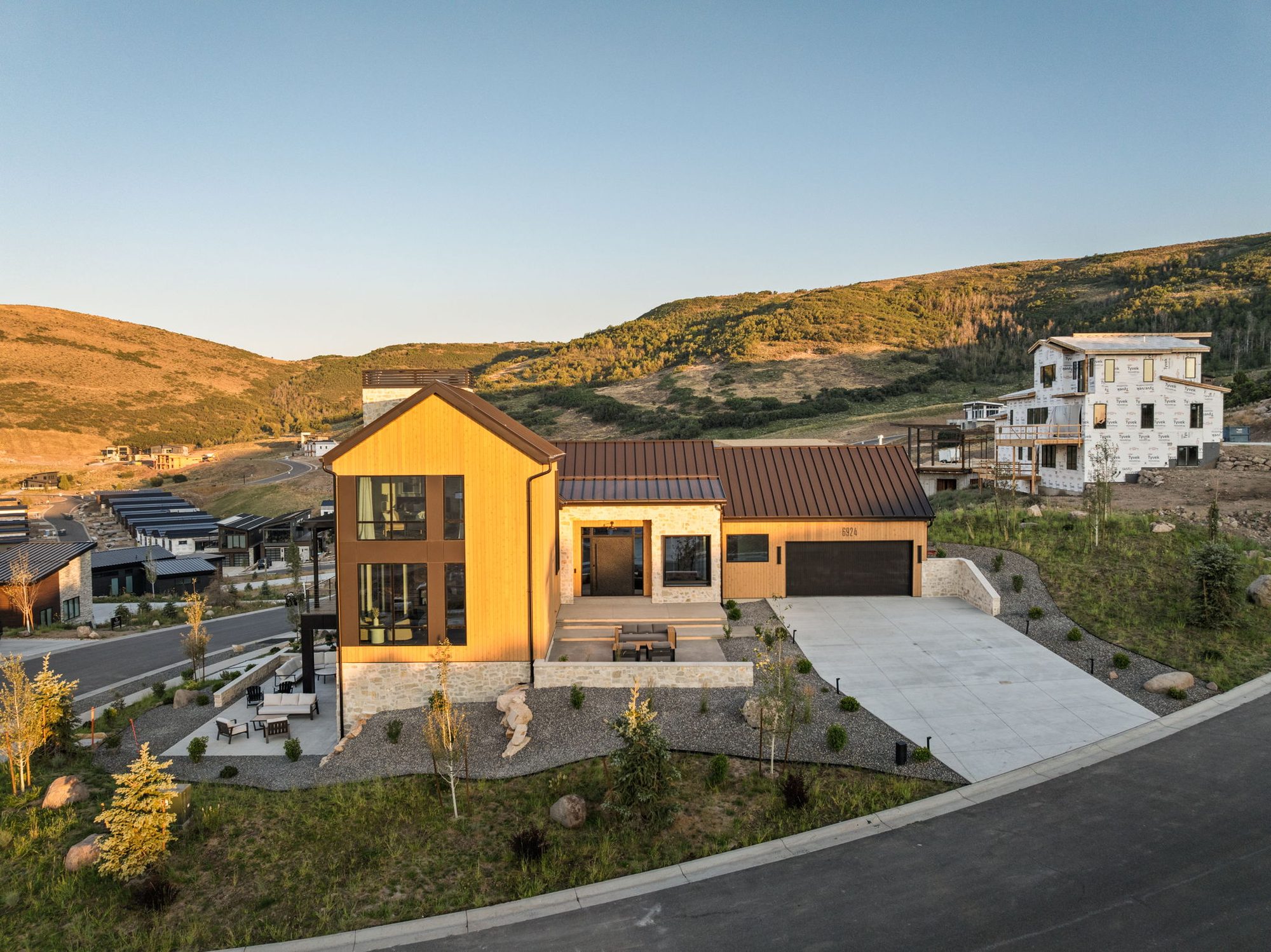 Lumen — aerial of the front elevation at dusk, Benloch Ranch, Heber City