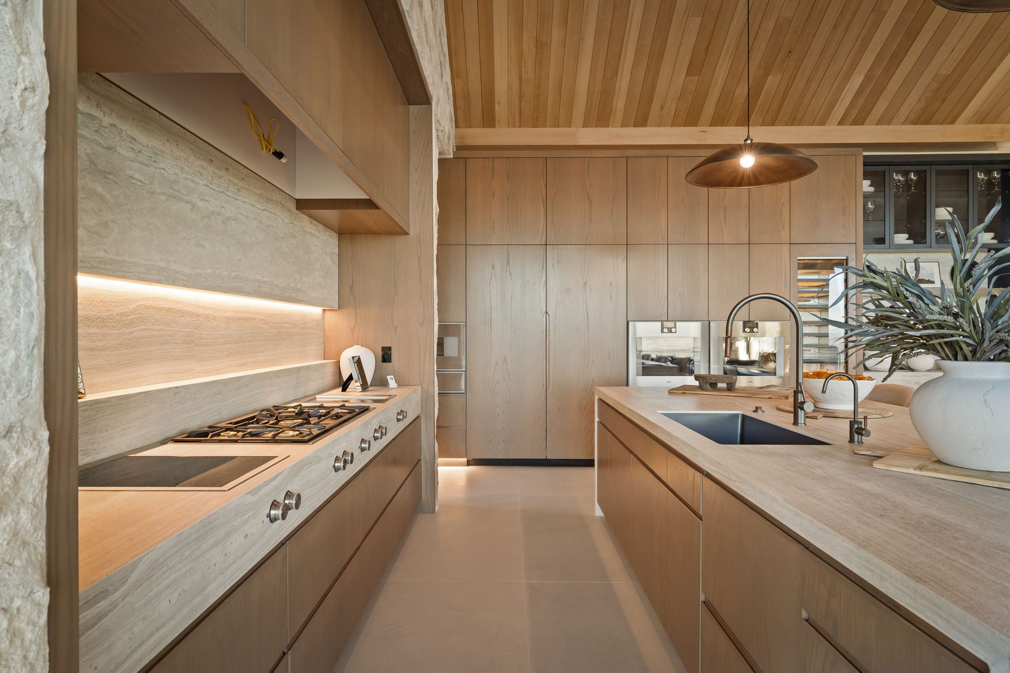 Lumen — kitchen range wall in white oak with an integrated hood