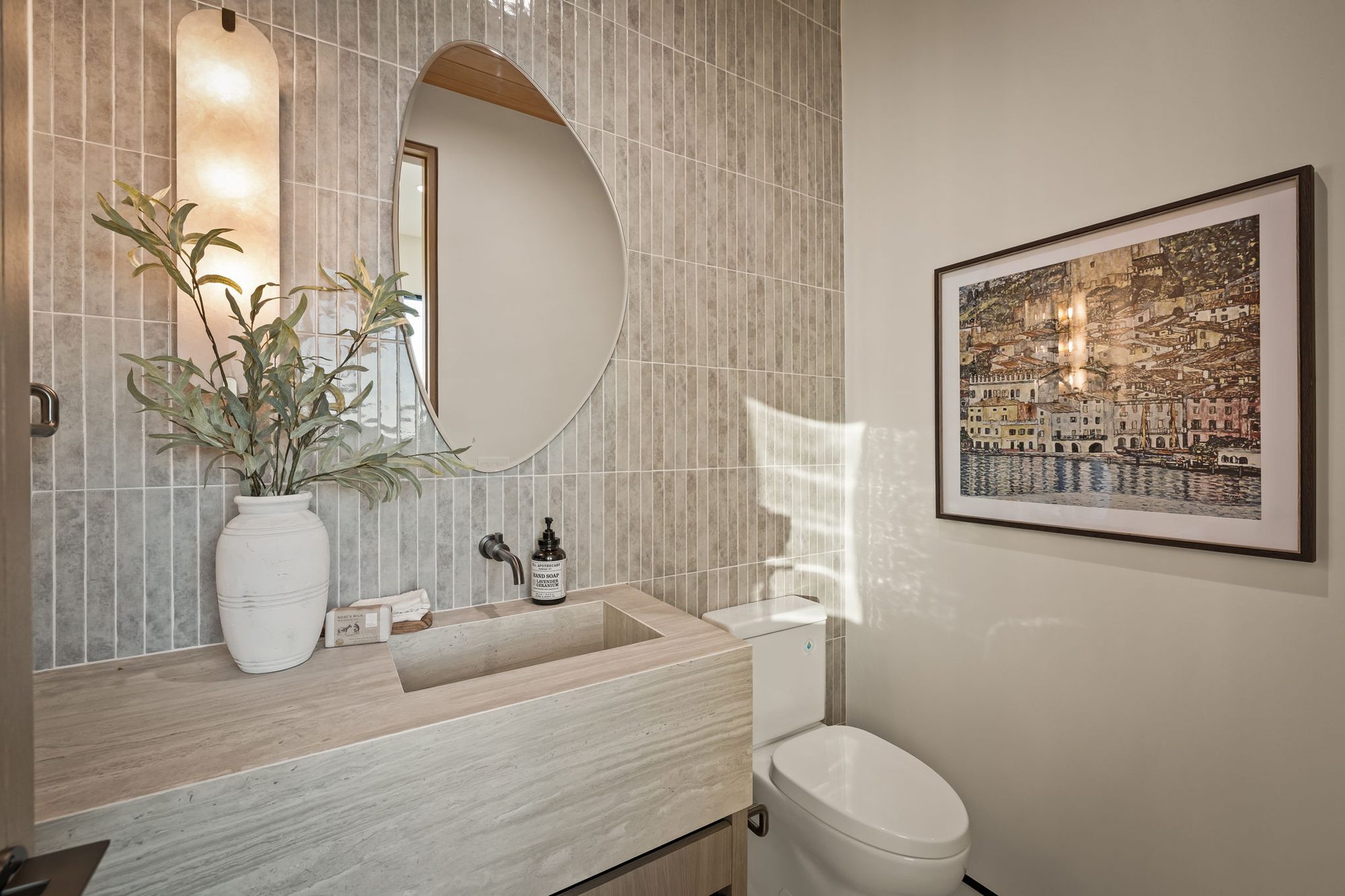 Lumen — powder room in vertical tile with a stone trough sink