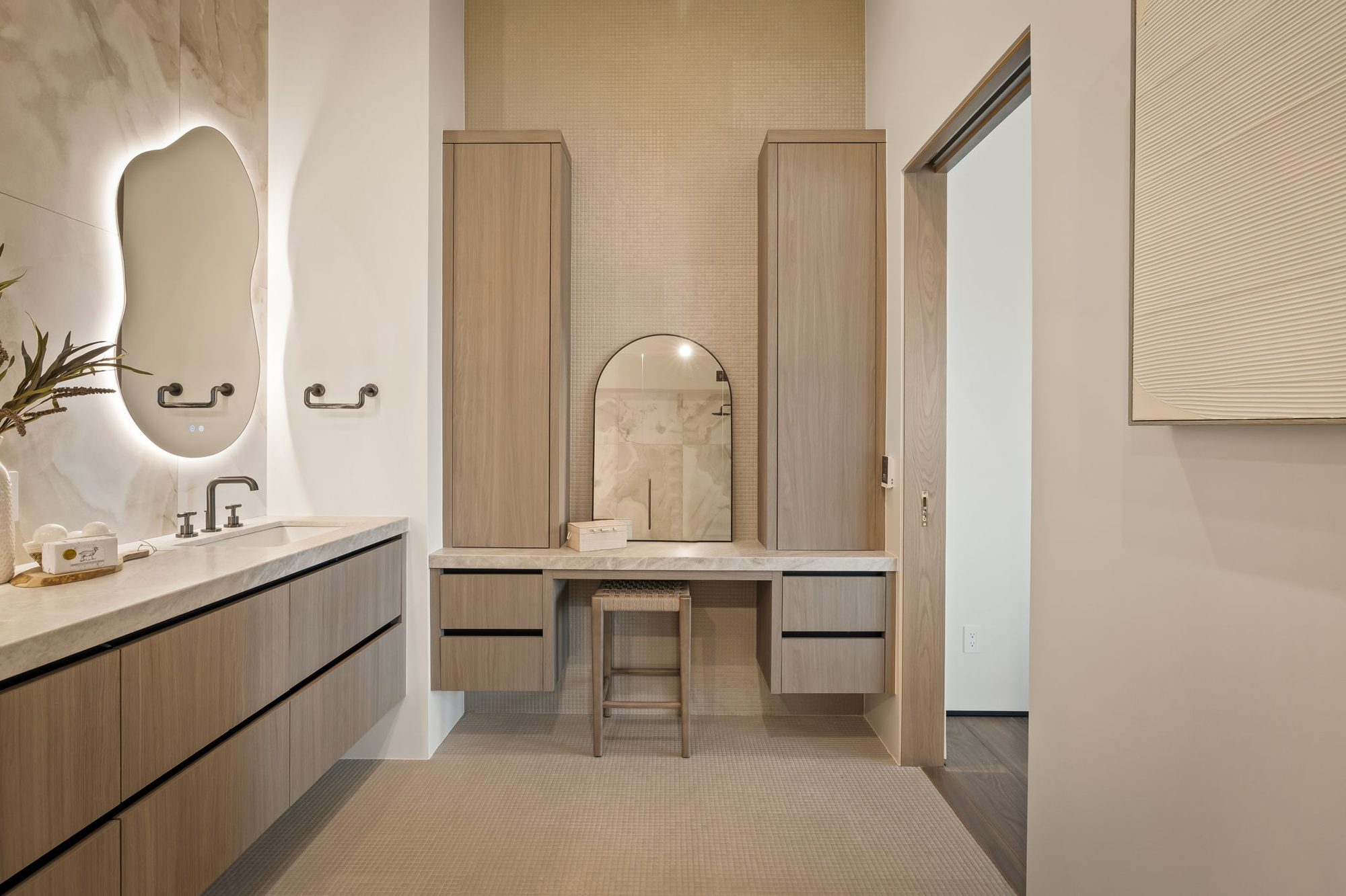 Lumen — primary bath with a double vanity, makeup table and backlit mirror