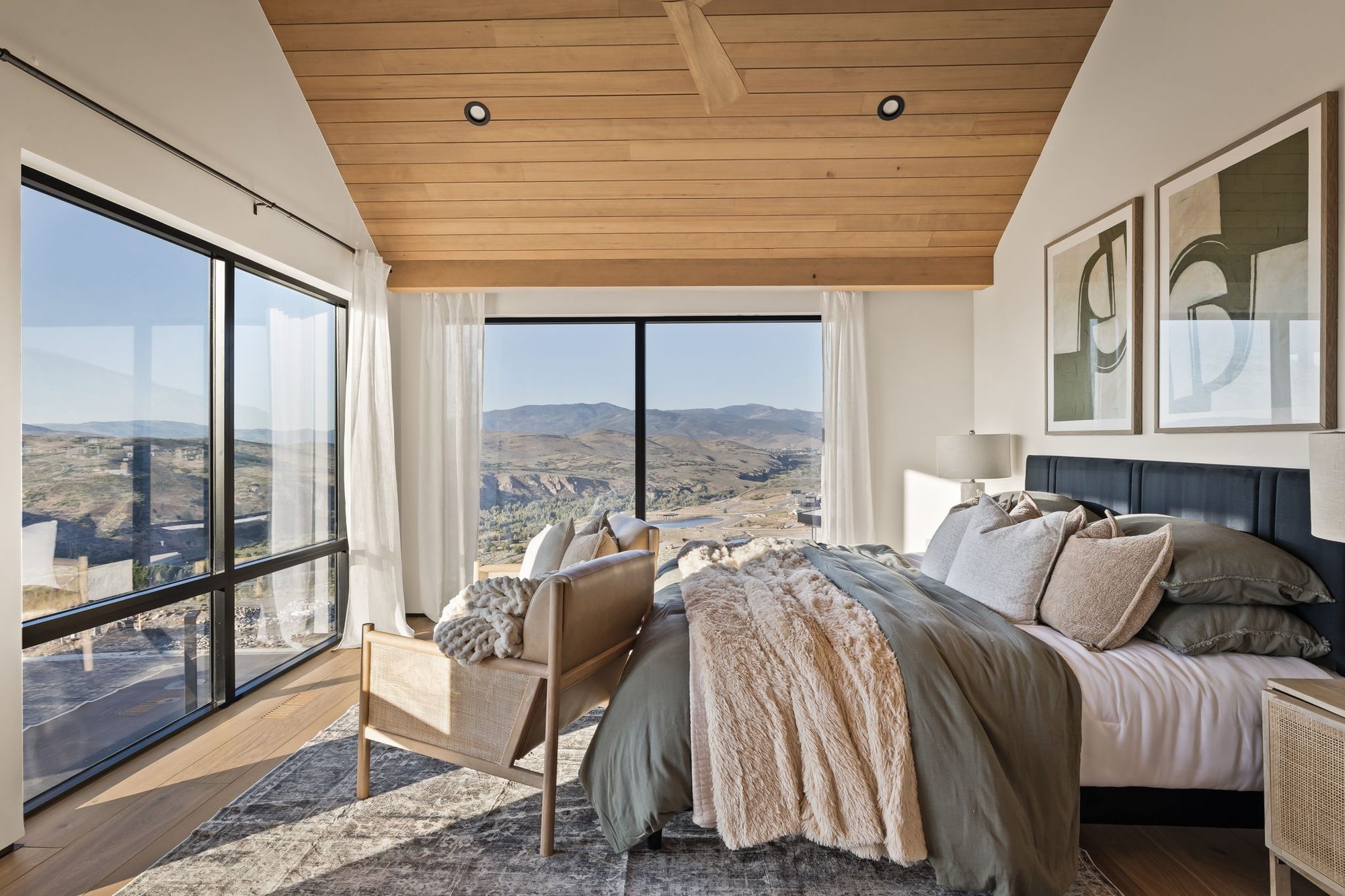 Lumen — primary bedroom with corner glass and the valley beyond