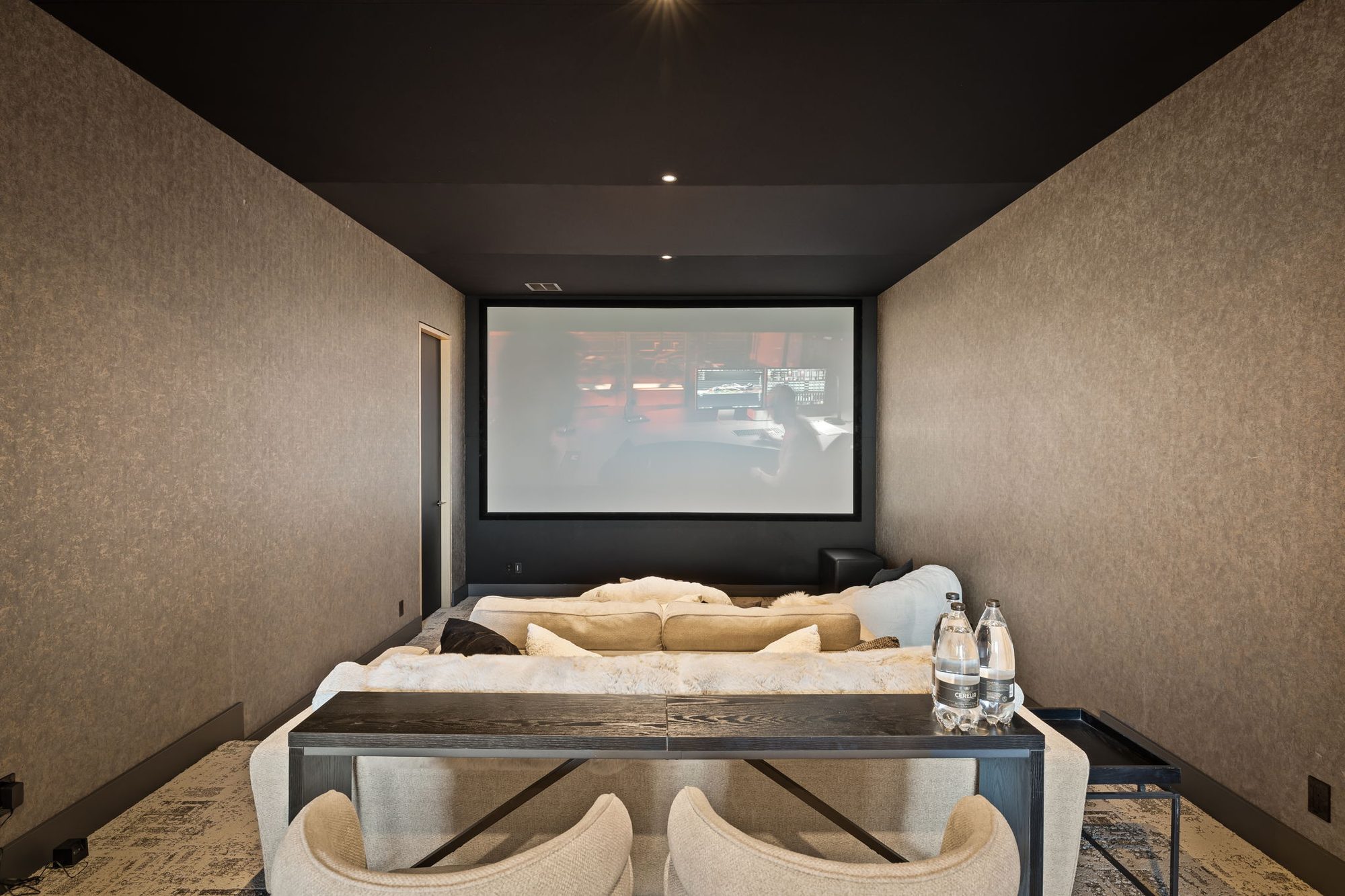 Lumen — theater room with projection screen and lounge seating