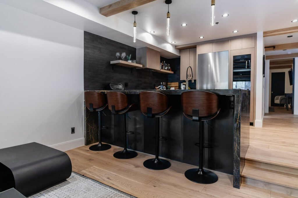 Main Street — stone-clad bar with walnut stools in the lower level