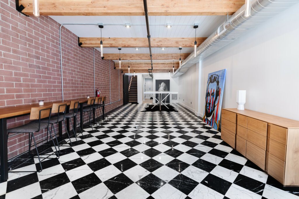 Main Street — main level with exposed brick, timber beams and checkerboard marble floor