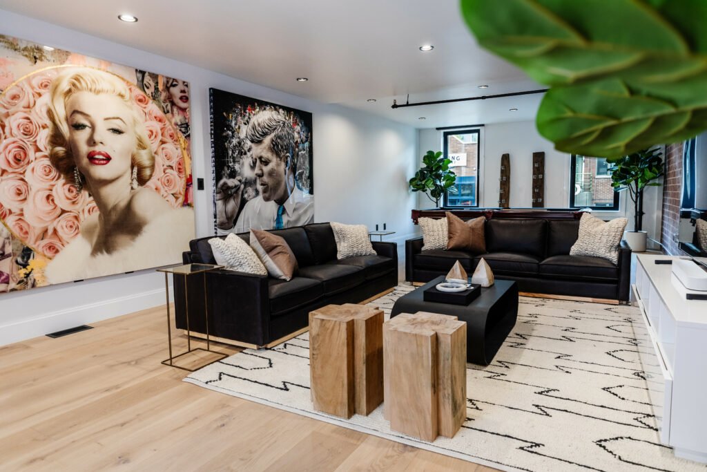 Main Street — media lounge with leather sofas and pop-art gallery wall