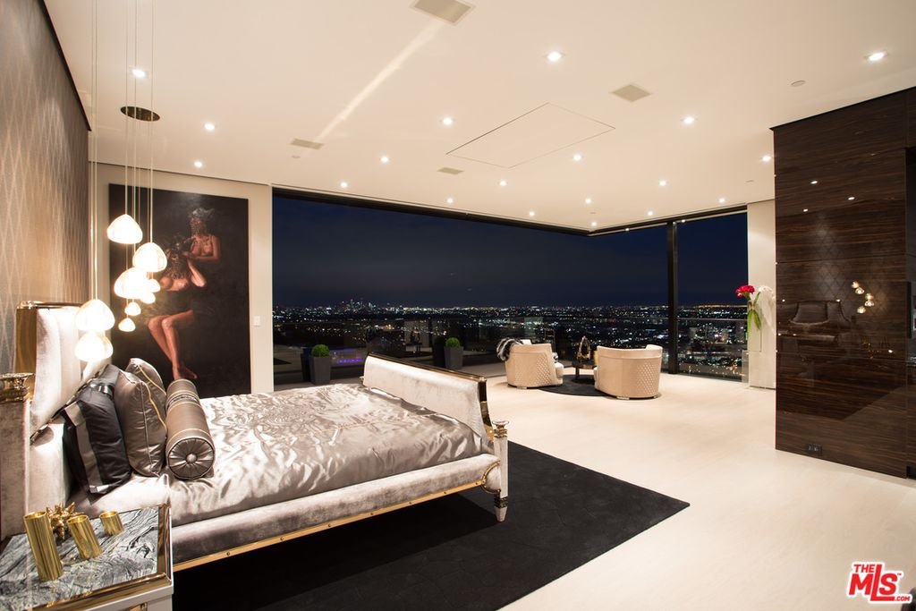 Thrasher Ave — master bedroom with floor-to-ceiling glass and skyline views at dusk