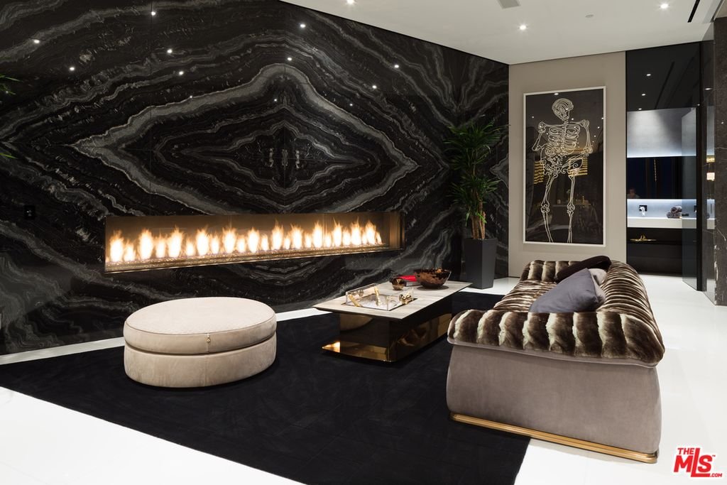 Thrasher Ave — lounge with linear fireplace set in book-matched black marble